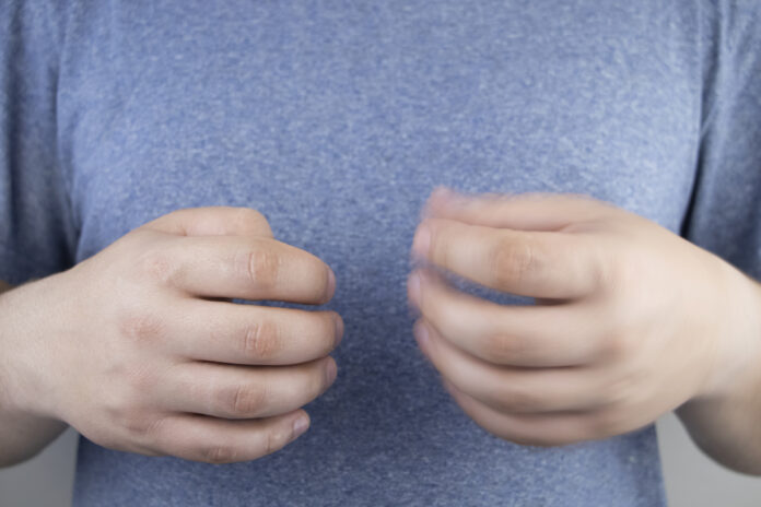 A patient with Parkinson's disease has trembling hands. Tremor of the extremities in various diseases. Patient care concept.