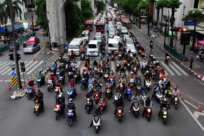 Motorcyclists,Wait,At,A,Junction,During,Rush,Hour,On,Aug